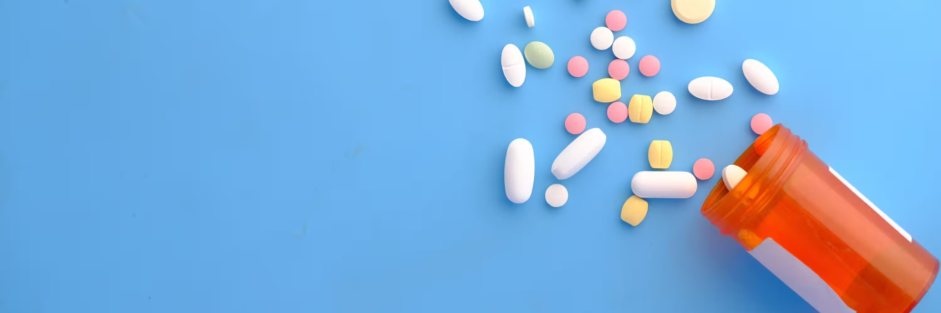 A bottle of colourful pills